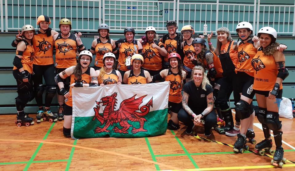 Tiger Bay Brawlers team picture at Finvitational in Finland with Welsh dragon flag